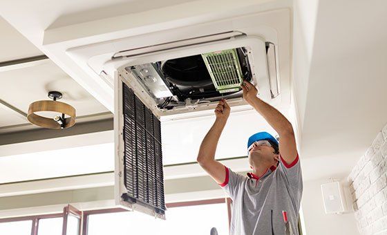Worker Installing the Air Conditioner — La Quinta, CA — Gibson Air Conditioning & Heating Inc