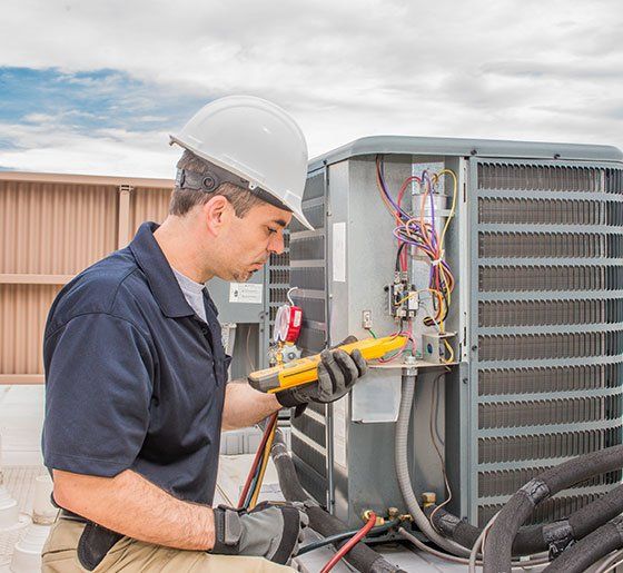 Technician Checking the Air Conditioner — La Quinta, CA — Gibson Air Conditioning & Heating Inc