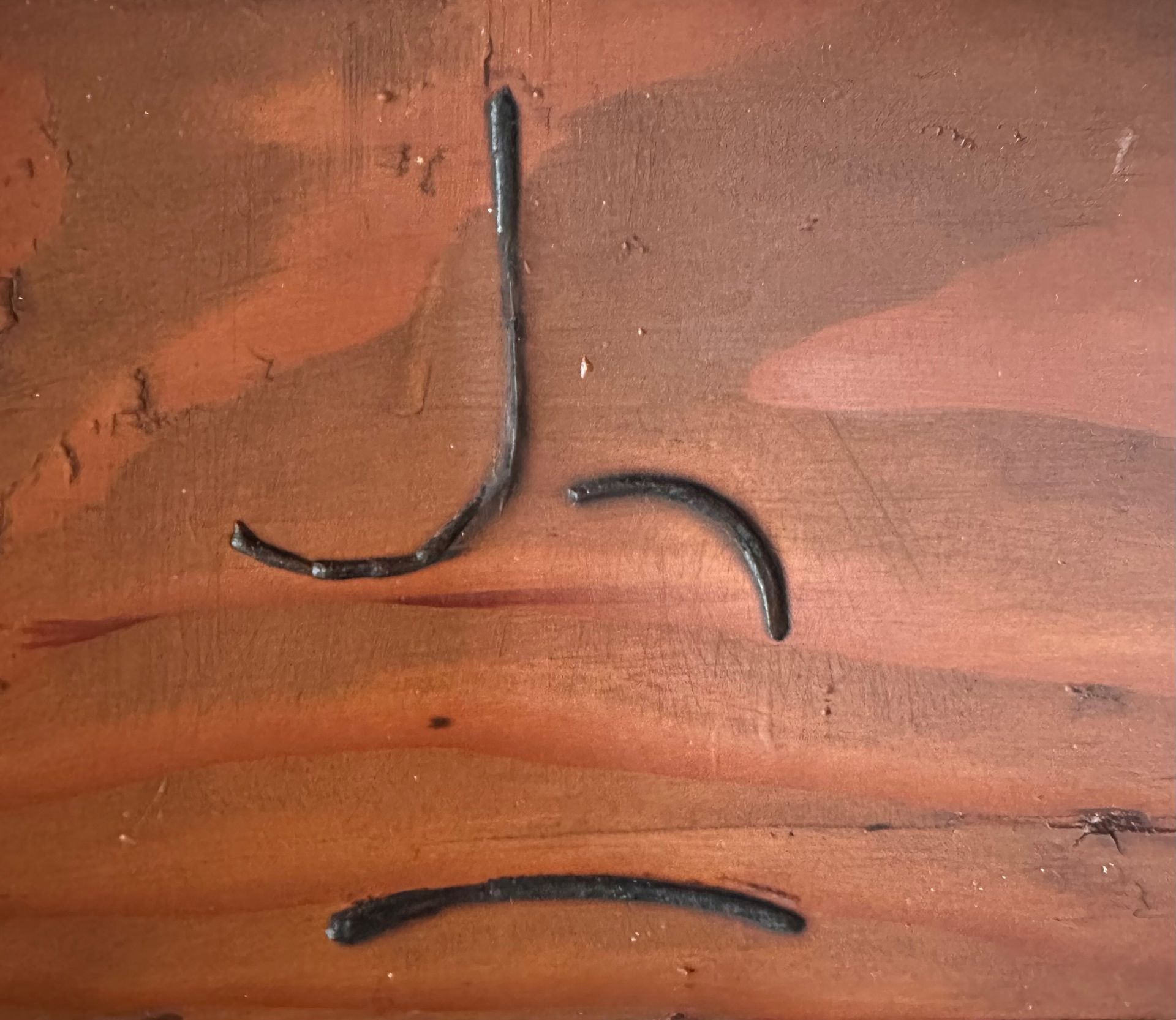 A close up of a piece of metal on a wooden surface.