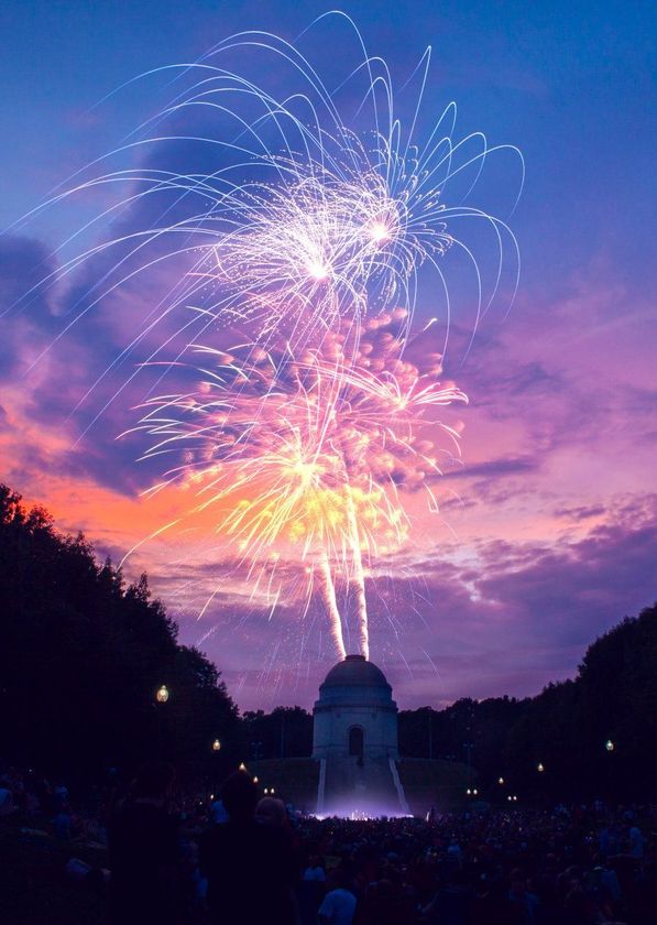 A fireworks display with a dome in the background