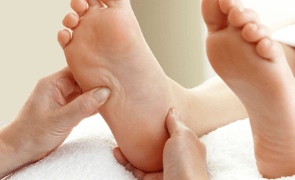 A pair of feet being massaged 