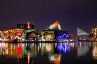 A wooden structure with a city skyline in the background.