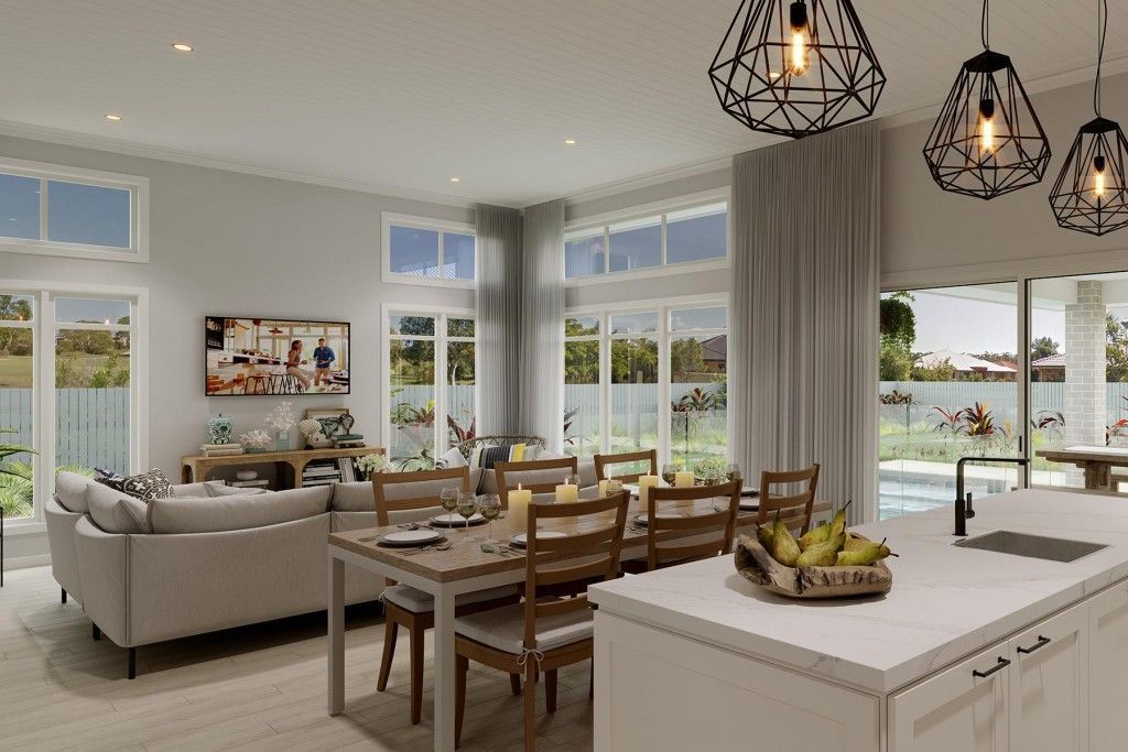 Open-concept living area with dining table, kitchen island, and a sofa, overlooking an outdoor patio — L & K Electrical & Air Conditioning in Scone, NSW