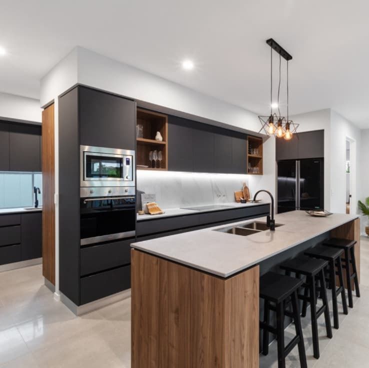 A Kitchen With Black Cabinets And A Large Island — L & K Electrical & Air Conditioning in Tamworth, NSW