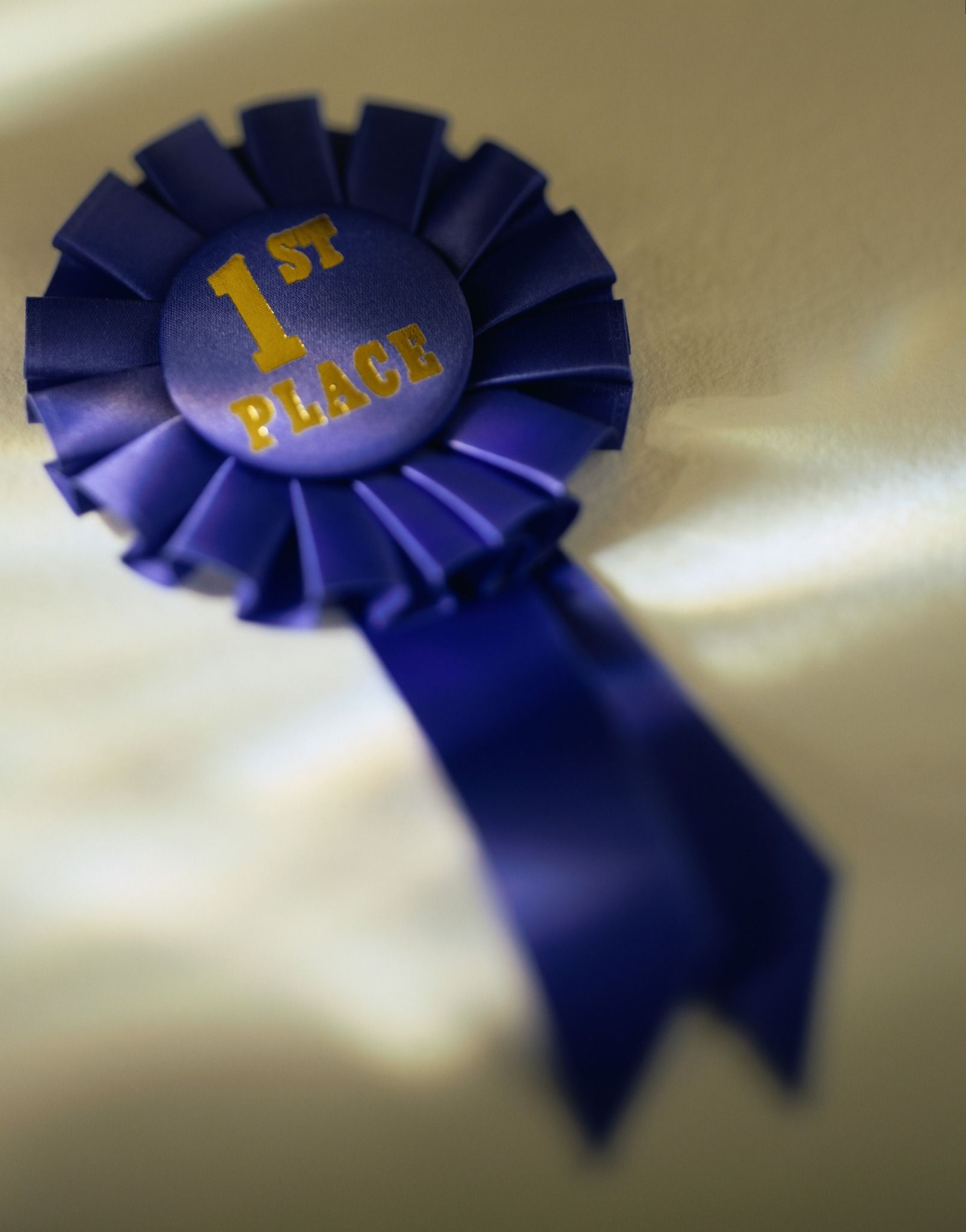 A blue ribbon that says 1st place on it
