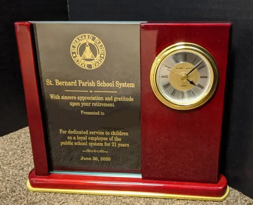 A st. bernard parish school system plaque with a clock