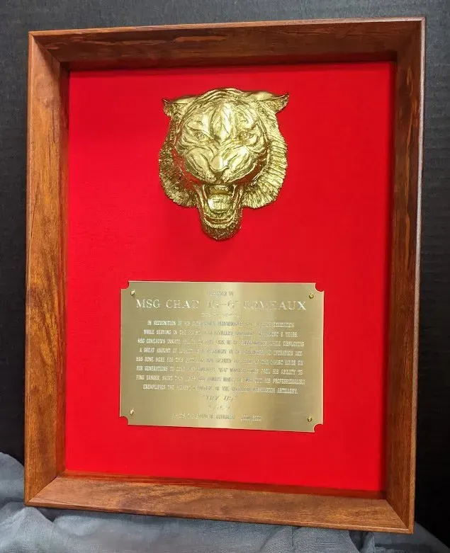 A framed plaque with a tiger head on it