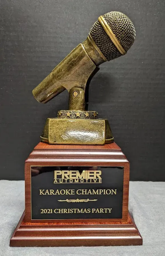 A trophy that says premier karaoke champion on it