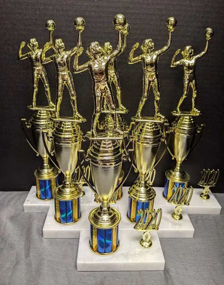 A bunch of trophies are stacked on top of each other