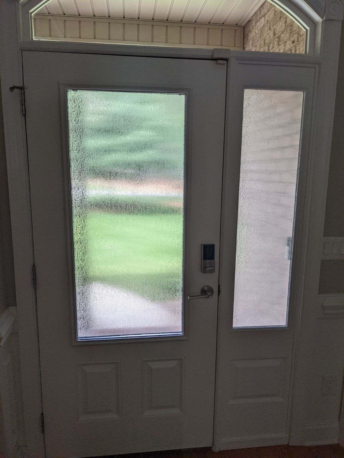 A room with stained glass windows and a green chair