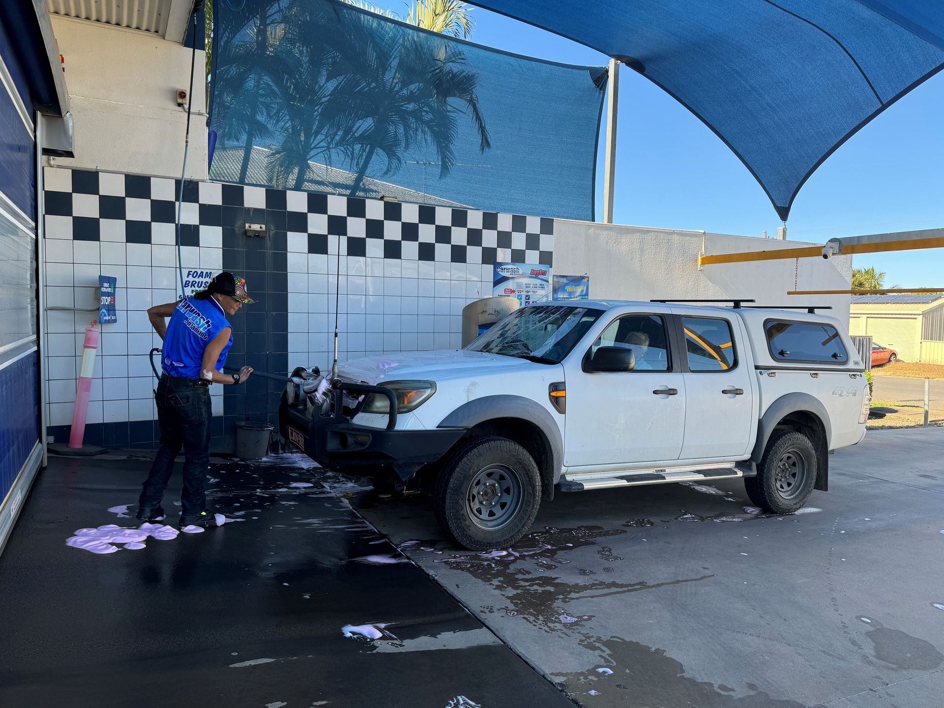 A Person Is Cleaning The Air Vents Of A Car With A Brush — Carwash On Canning In Allenstown, QLD