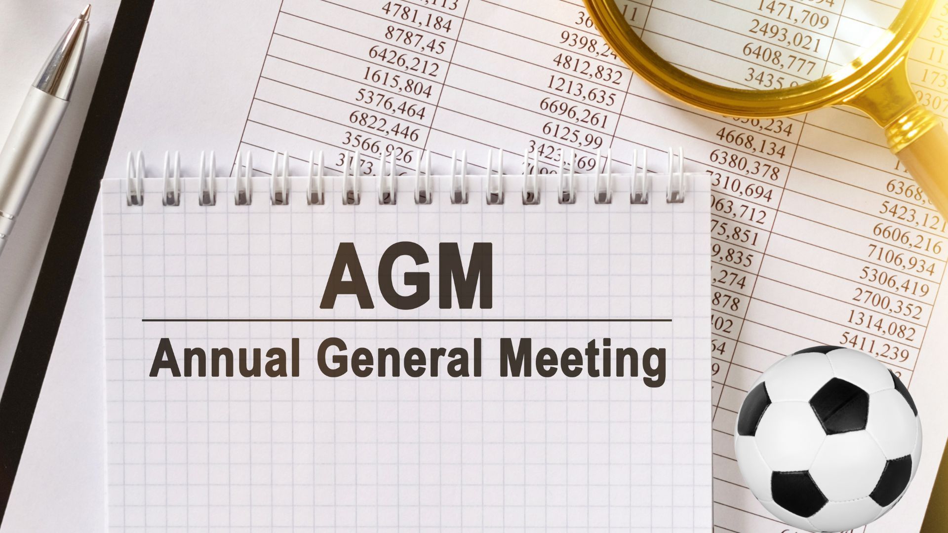 A notebook with the words agm annual general meeting written on it