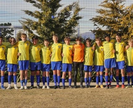 A group of soccer players are posing for a picture