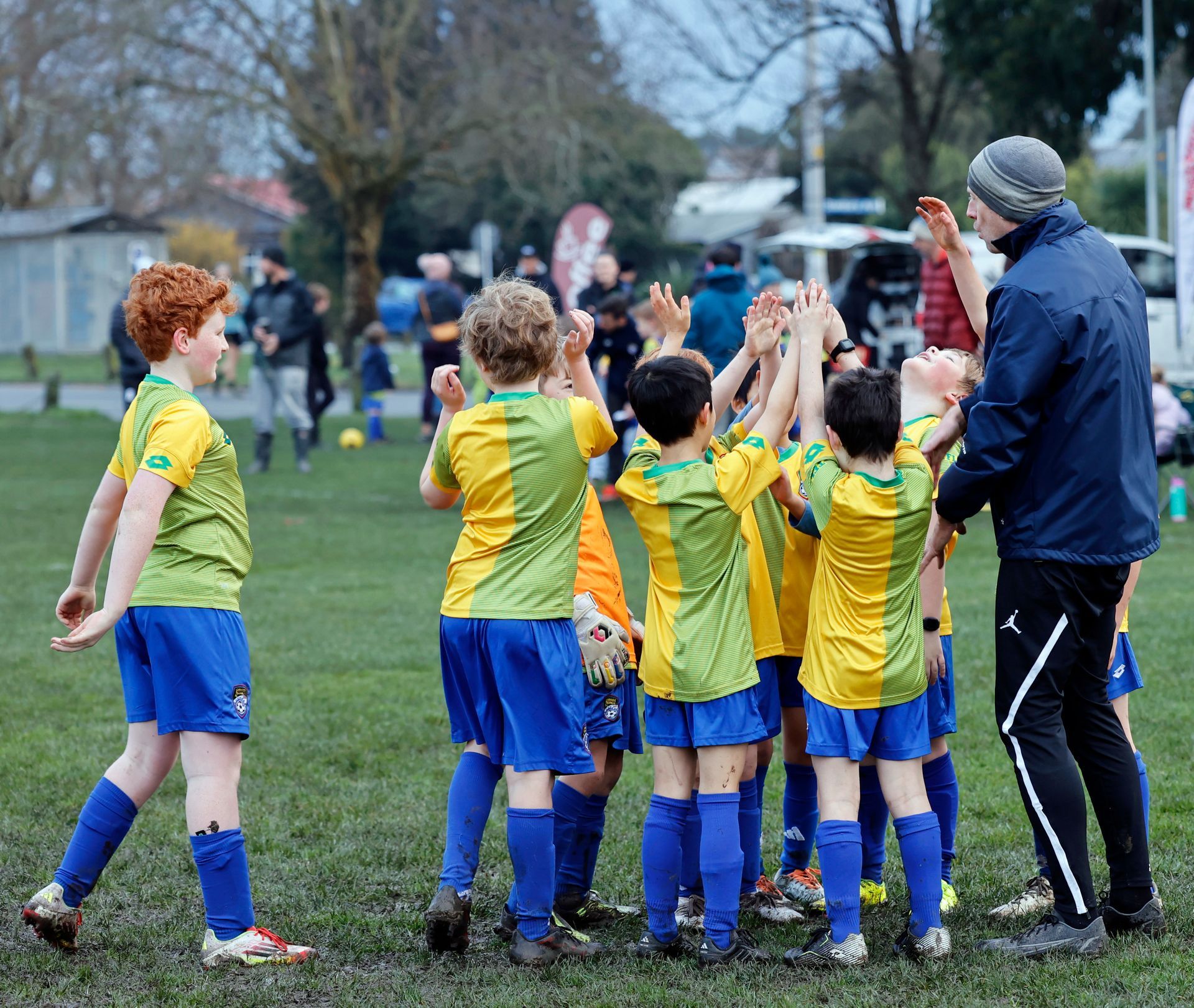 Two young boys are holding a picture frame that says players of the day.