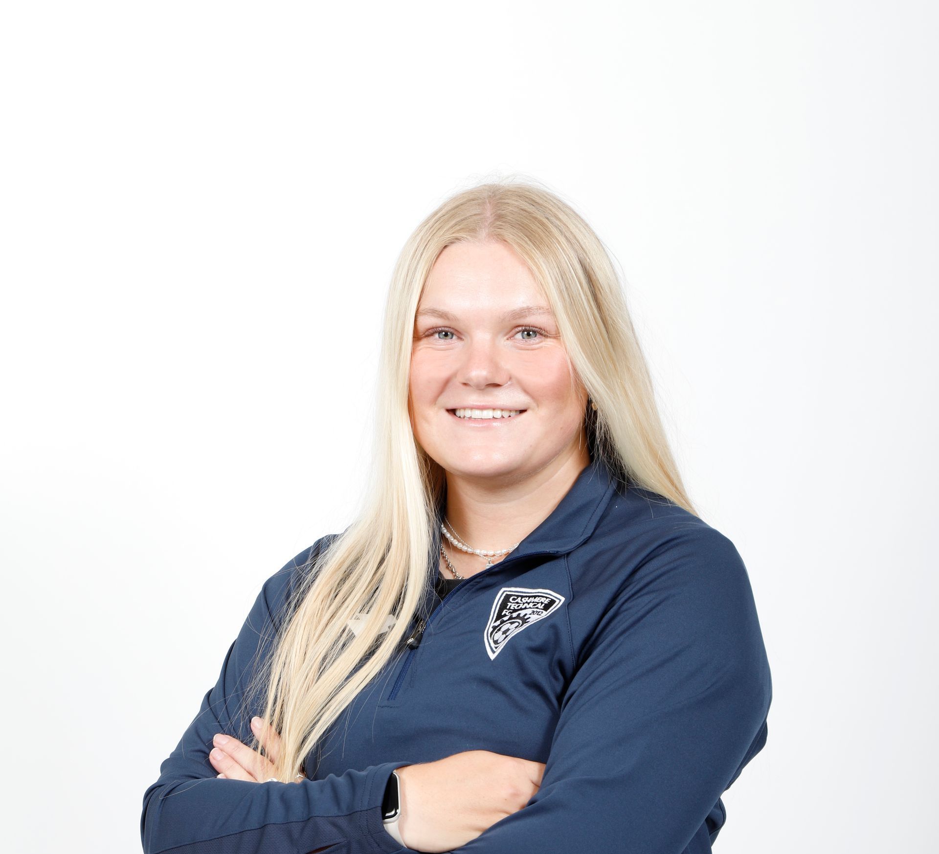 A group of people are sitting in a circle on a field.