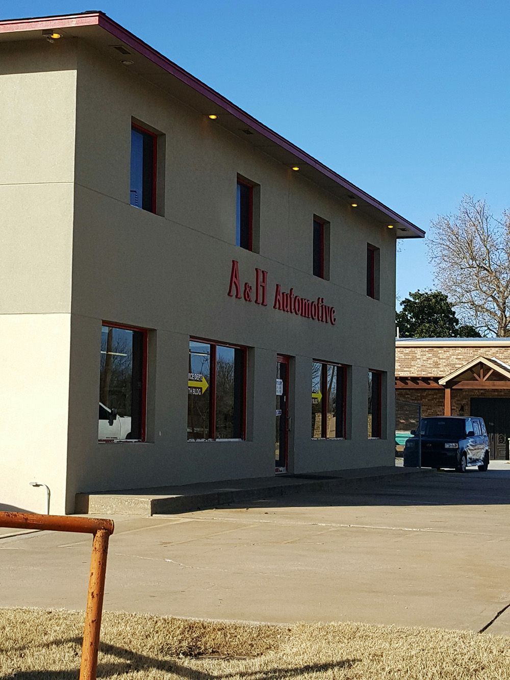 A building with a red sign that says A & H Automotive