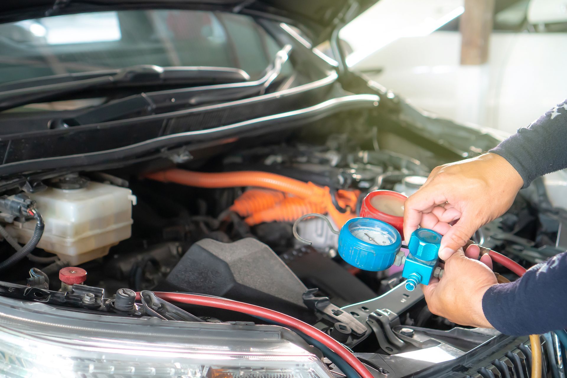 A person is working on the engine of a car.