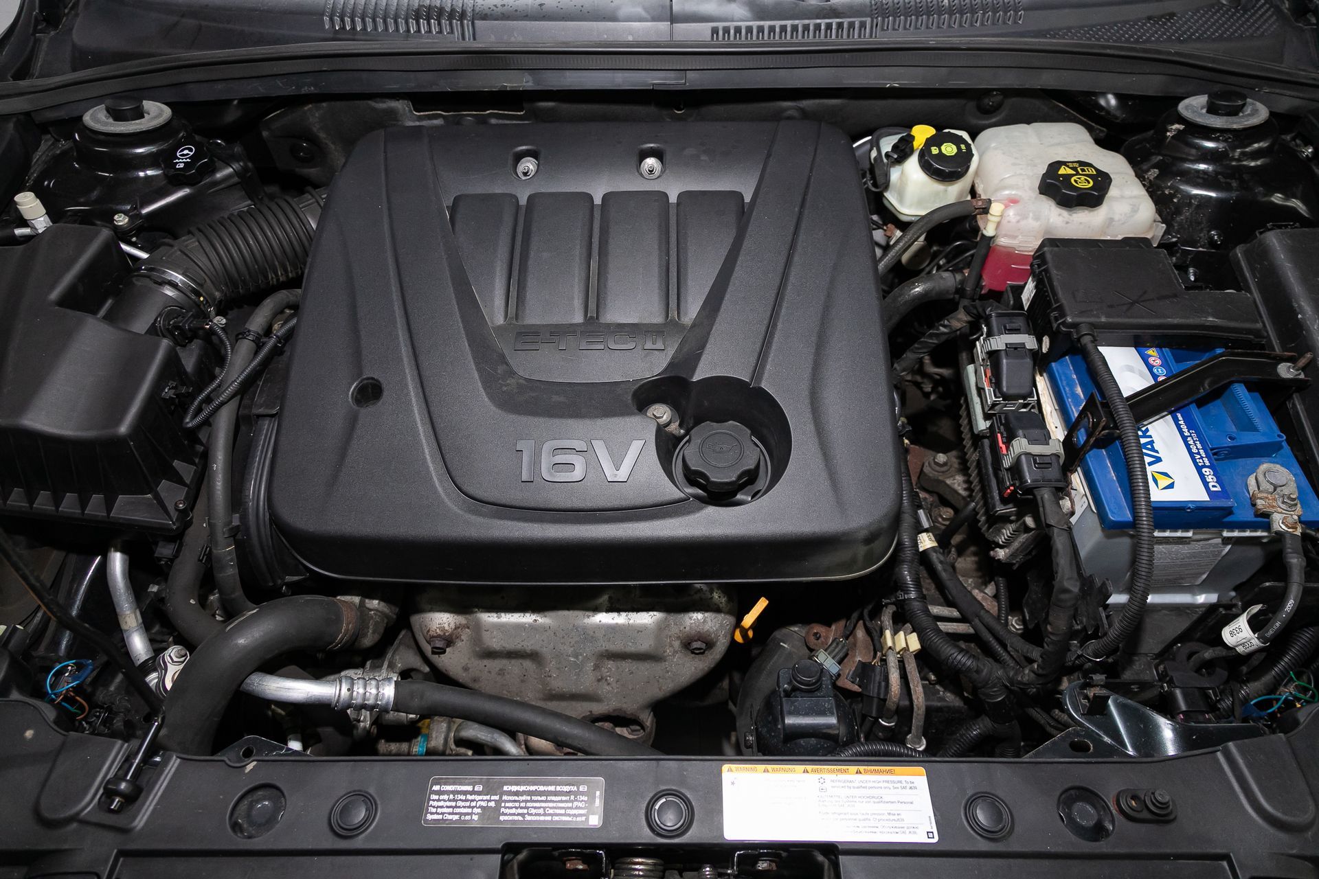 Car engine, black cover labeled 