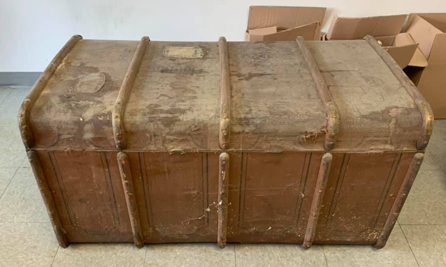 Before restoration of antique leather and wood trunk