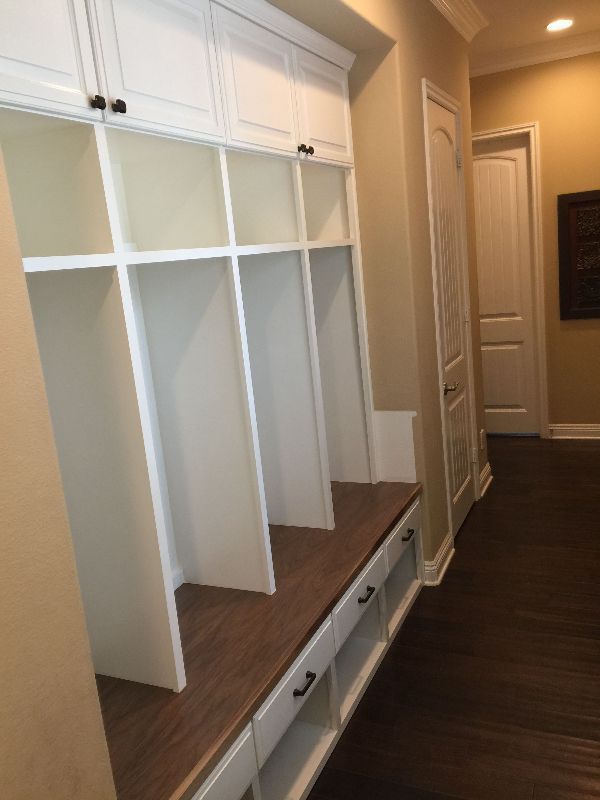 A hallway with lots of shelves and drawers