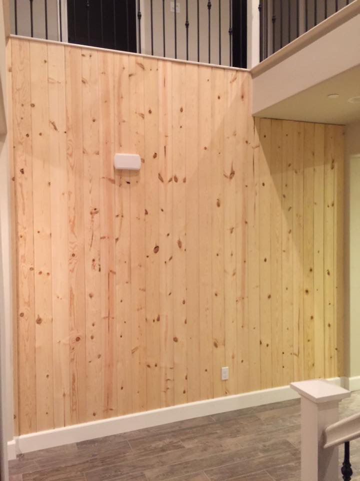 A room with wood paneled walls and a staircase