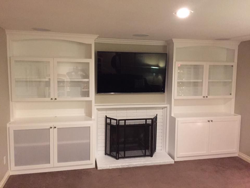 A living room with a fireplace and a flat screen tv