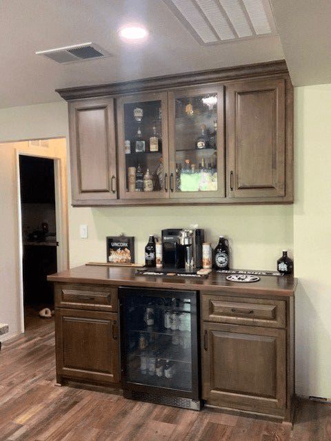 A kitchen with wooden cabinets and a refrigerator