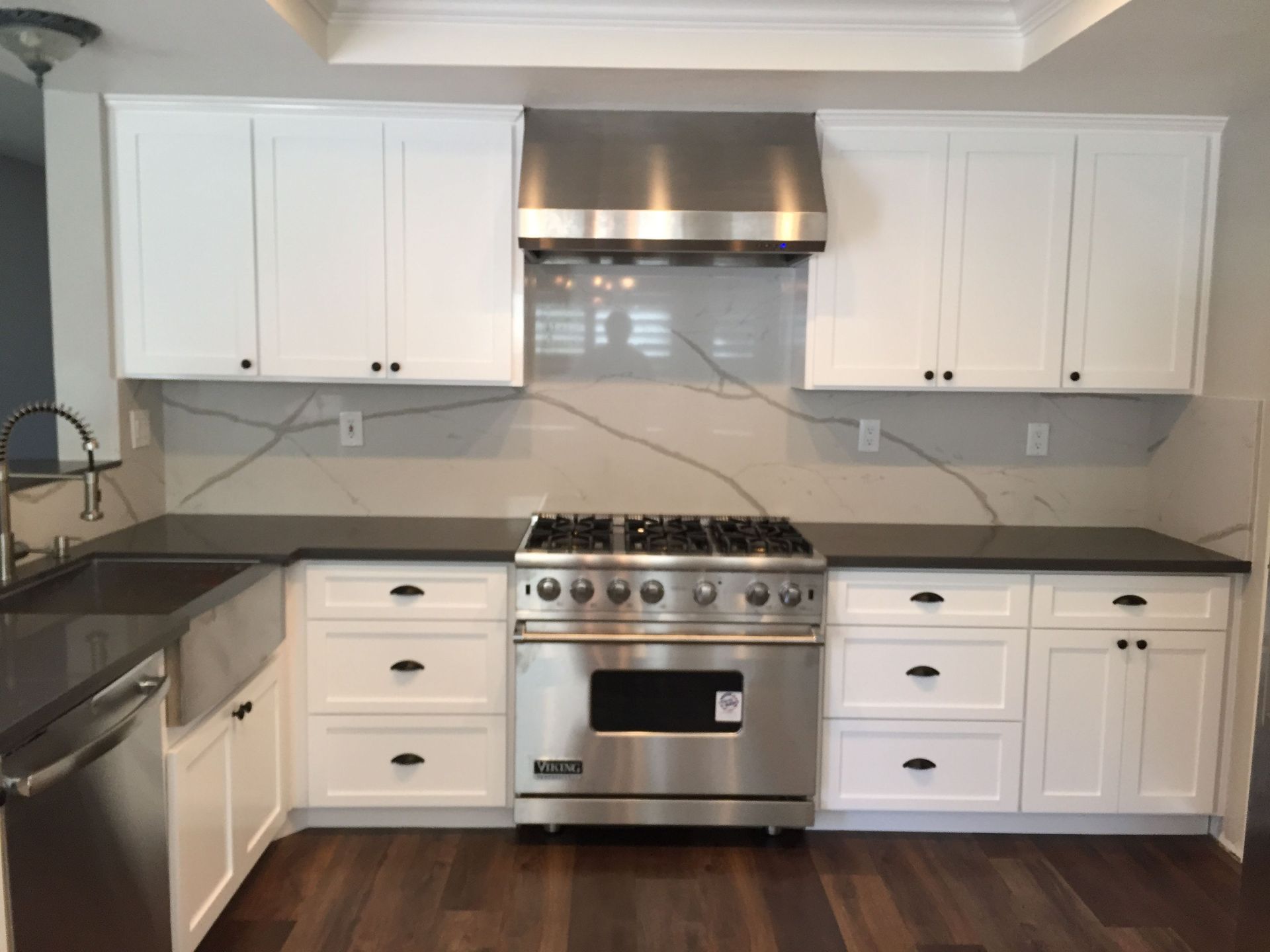 A kitchen with stainless steel appliances and white cabinets