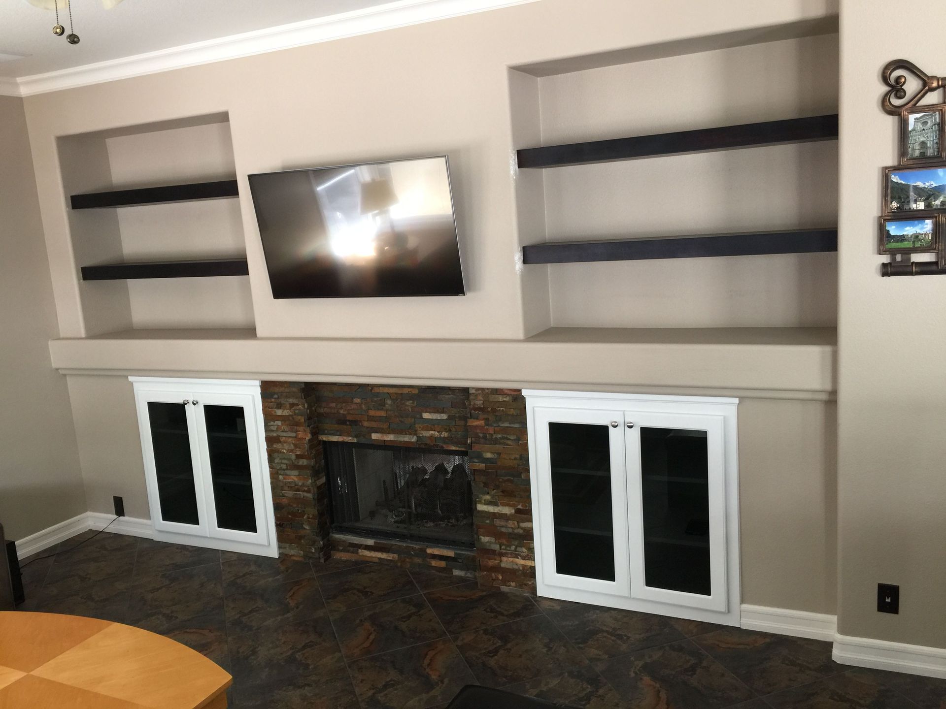 A living room with a fireplace and a flat screen tv