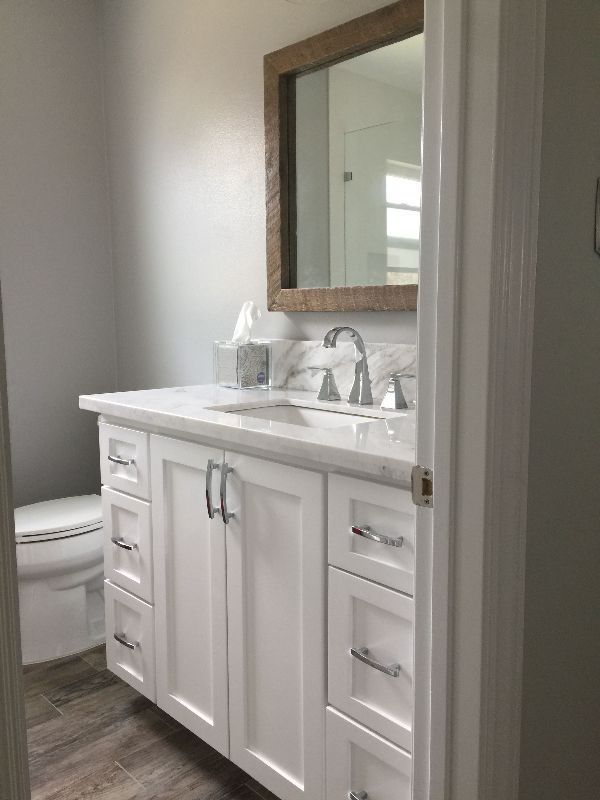 A bathroom with a sink , toilet and mirror