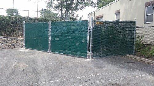 Black enclosures in front view — Fence Installation in Bronx, NY