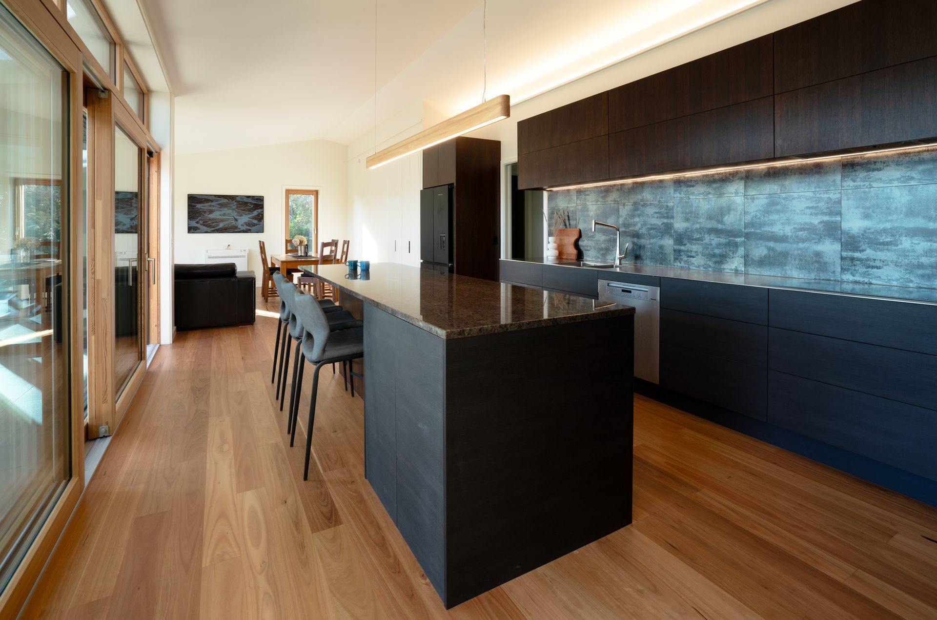 a kitchen with black cabinets and a large island
