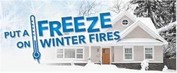 Sign promoting winter fire safety. Text reads: Put a freeze on winter fires with a thermometer graphic and a snowy house. Sign promoting winter fire safety. Text reads: Put a freeze on winter fires with a thermometer graphic and a snowy house.