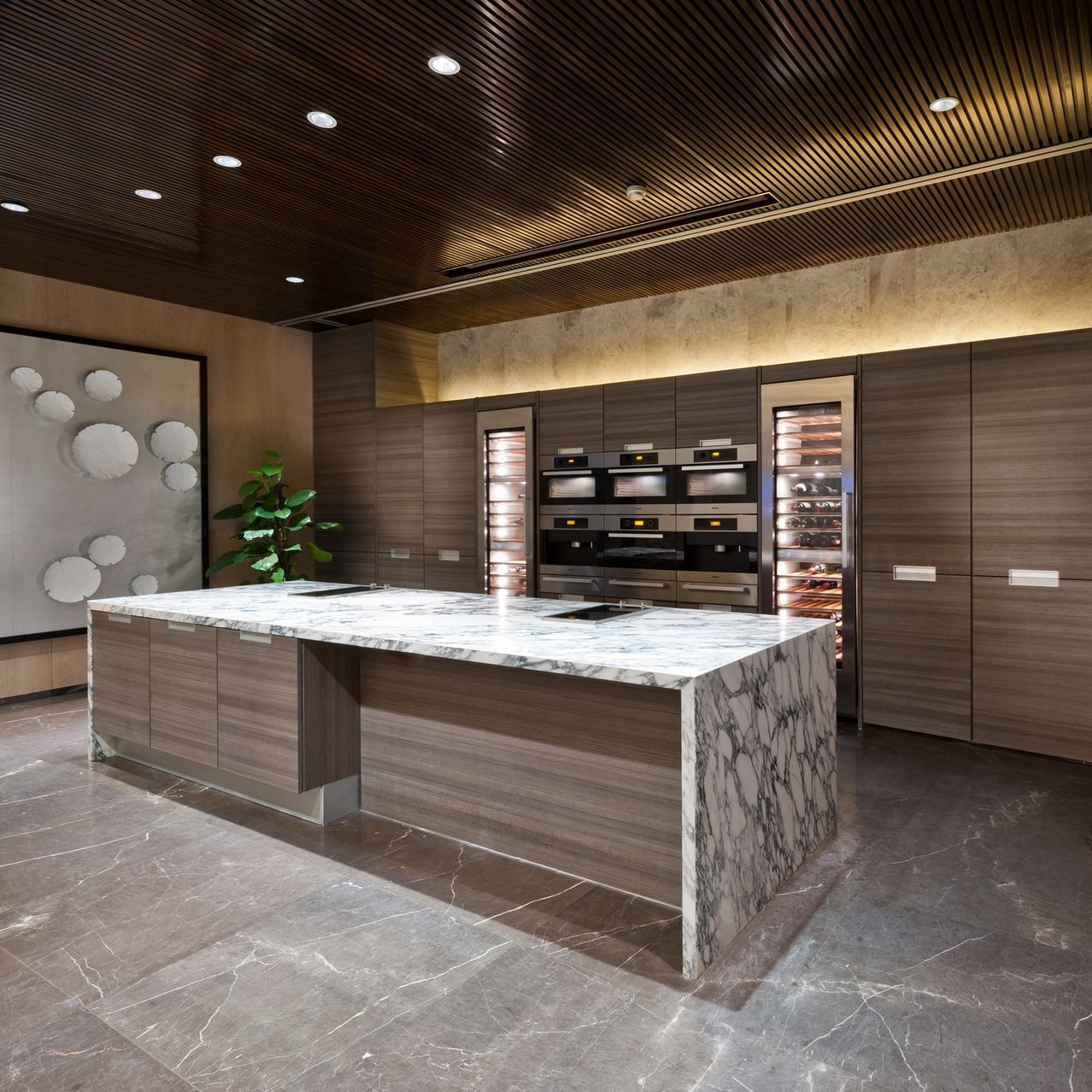 A kitchen with a large island in the middle of the room.