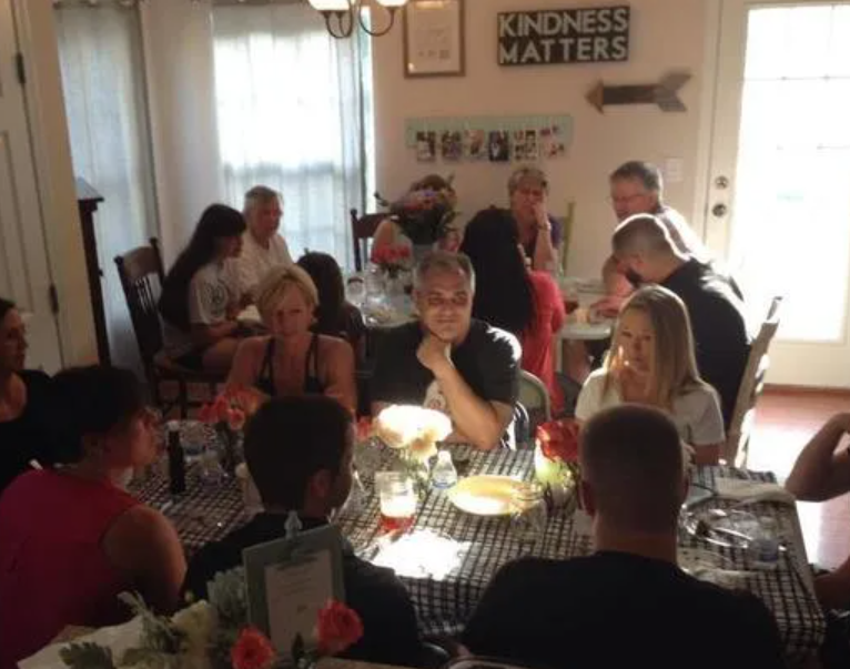 A group of people are sitting around a table