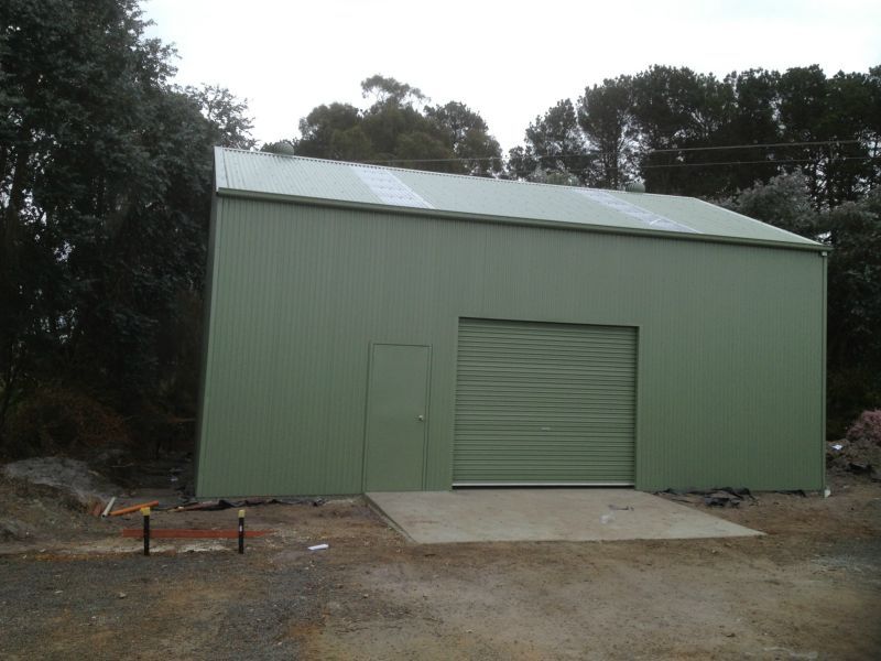 A Green Garage with Trees in the Background - Wallan, VIC - Victorian Garages & Barns