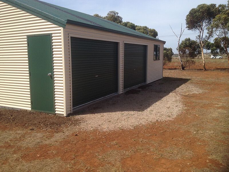 A White Garage with Green Doors - Wallan, VIC - Victorian Garages & Barns