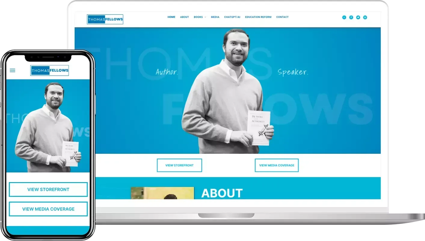 A man is holding a book in front of a laptop and a cell phone.