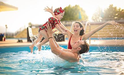 Pool Pump Repairs — Family Happily Swimming in Malibu, CA