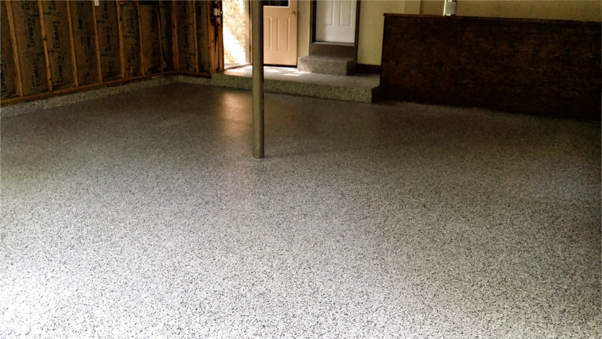 A garage with a concrete floor and a door.