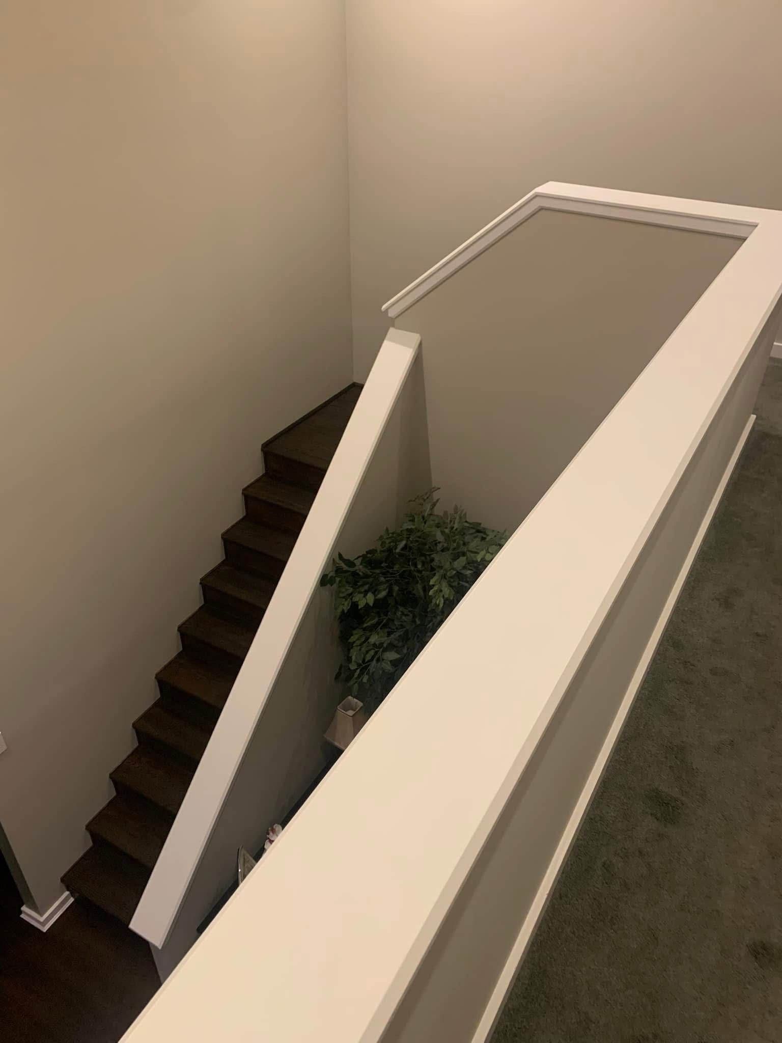 A view of a staircase from the second floor of a house.