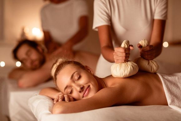 couple enjoying herbal massage