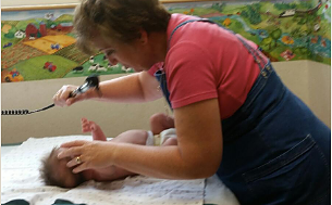 Health Worker Checking On A Baby — Leavenworth, KS — Lori Ann Golon M.D., P.A.