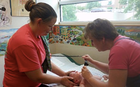 2 Pediatricians Checking On A Baby — Leavenworth, KS — Lori Ann Golon M.D., P.A.