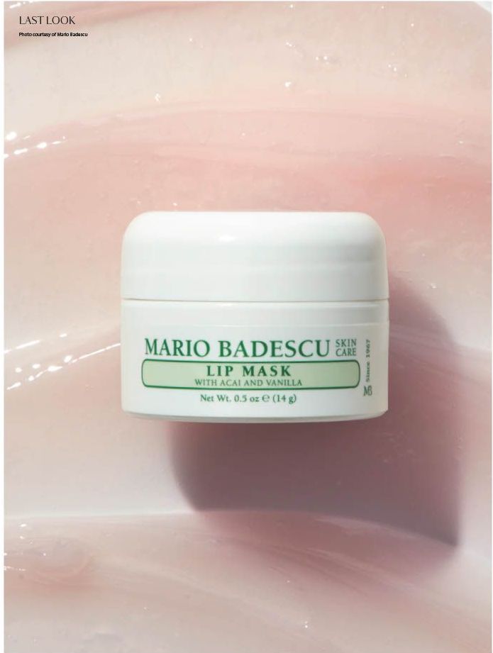 A white jar with the words Maro Badescu's Lip Mask in green, on top of a pale pink background