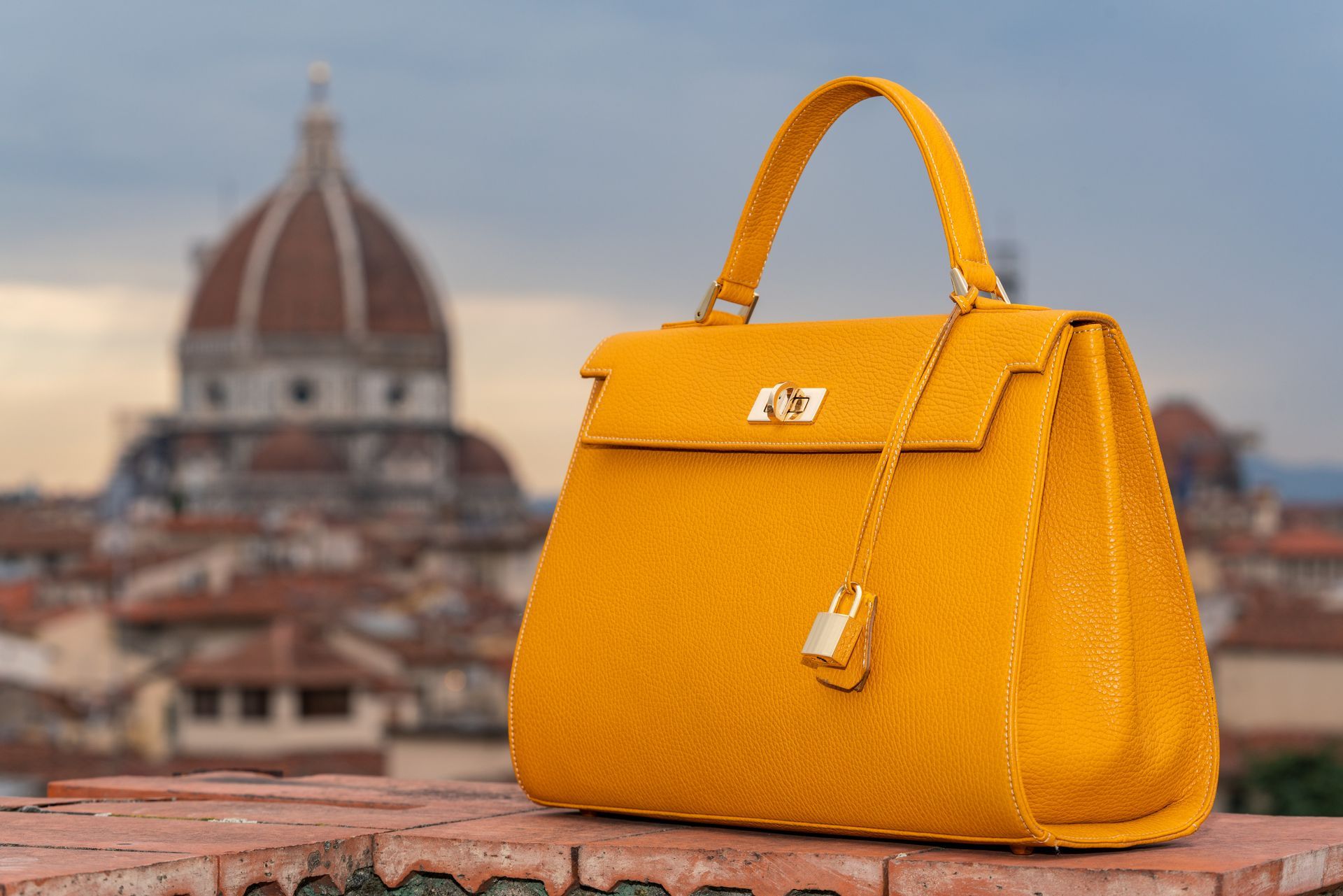An orange handbag sits in front of the Duomo in Florence. 