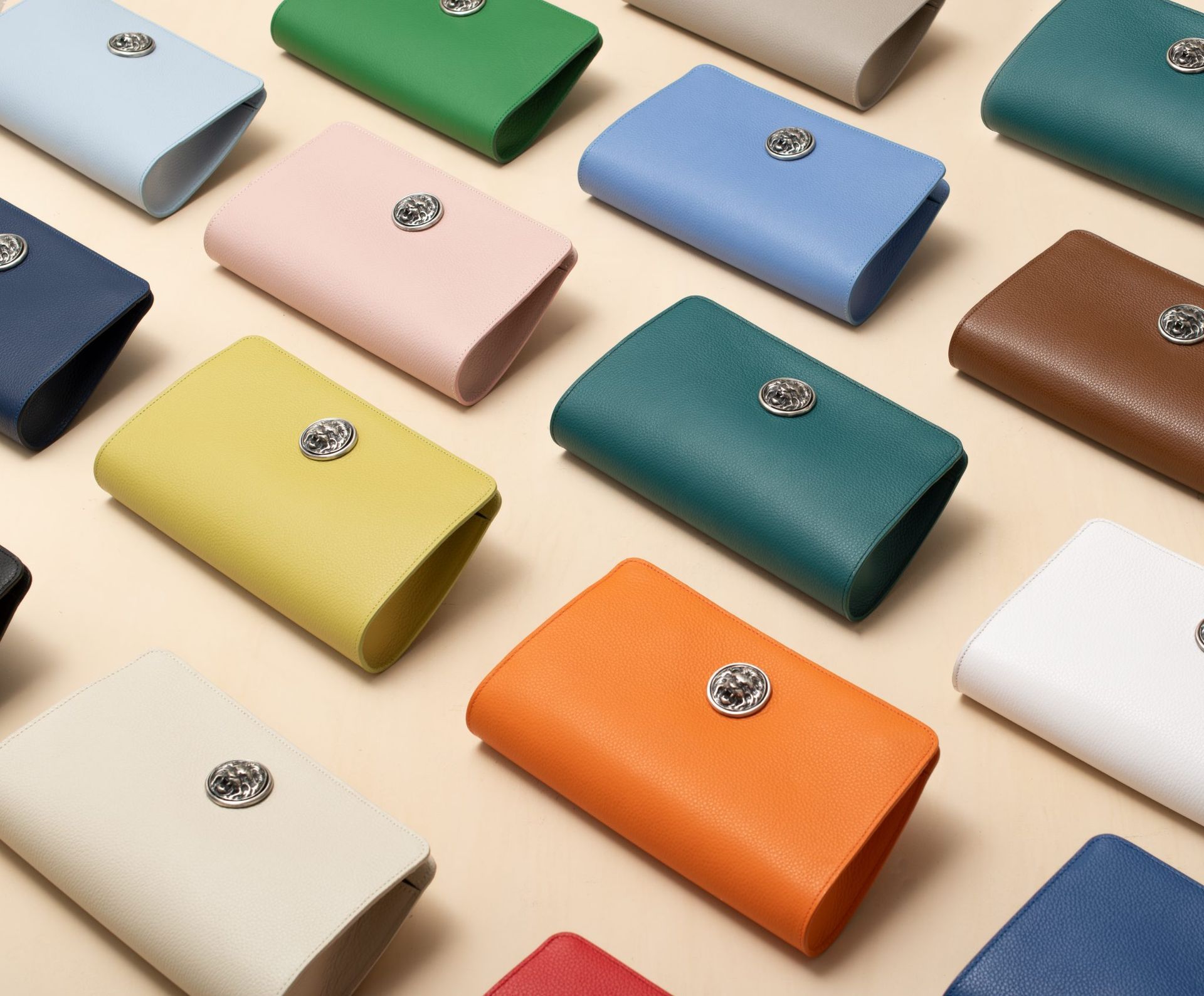 Colorful clutch bags on a beige background