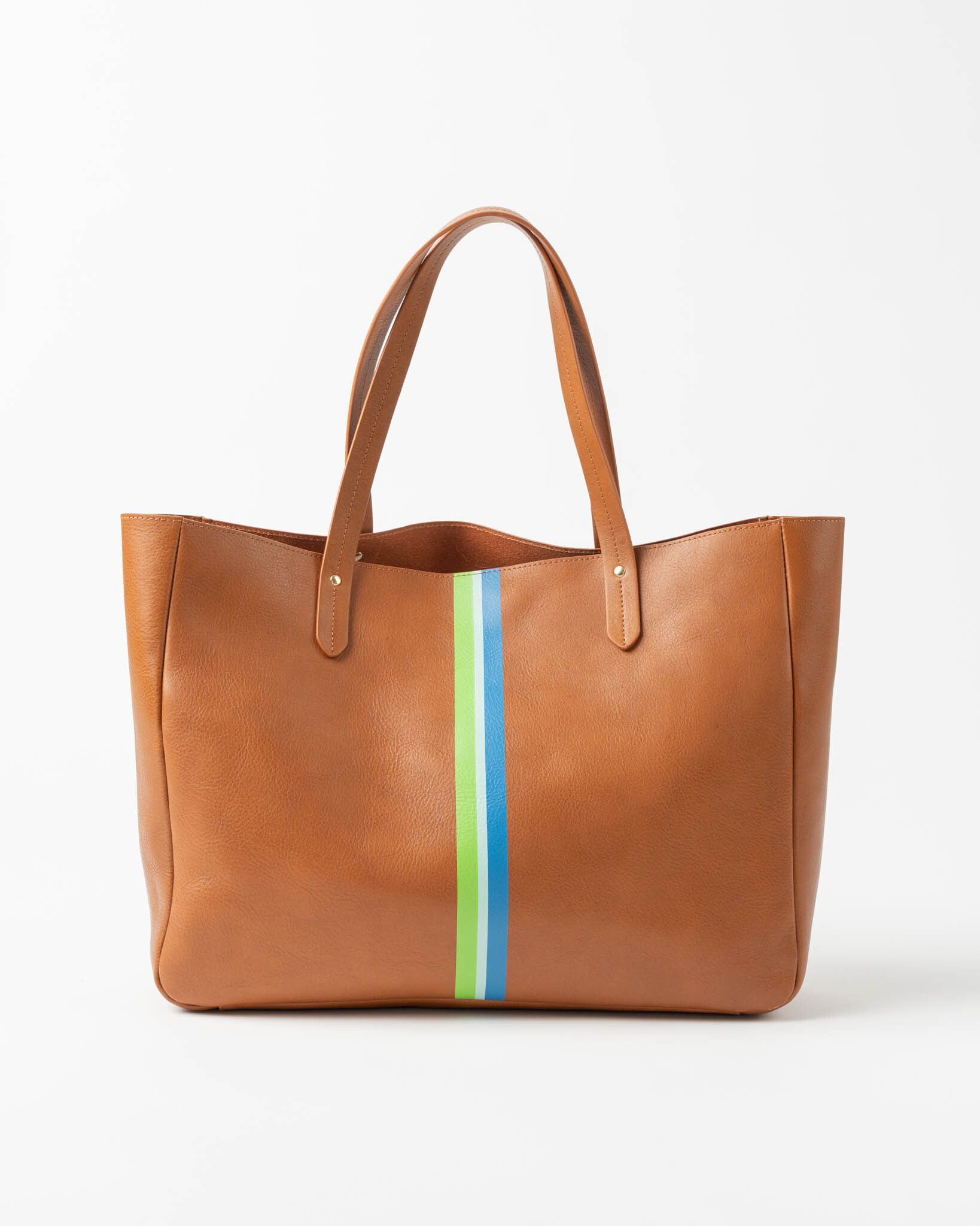 A brown leather tote bag with a green, white, and blue stripe down its center, sitting on a white background