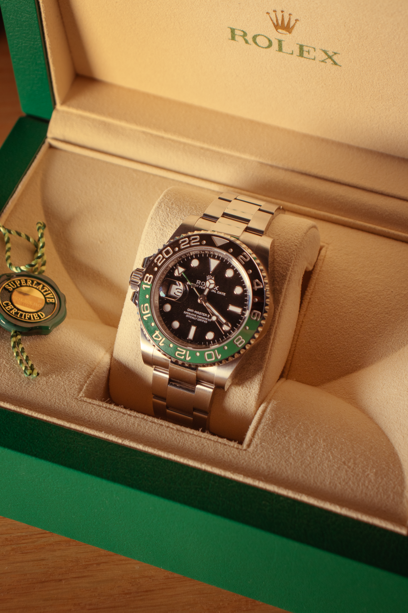 A Rolex watch in a beige, cloth-lined box
