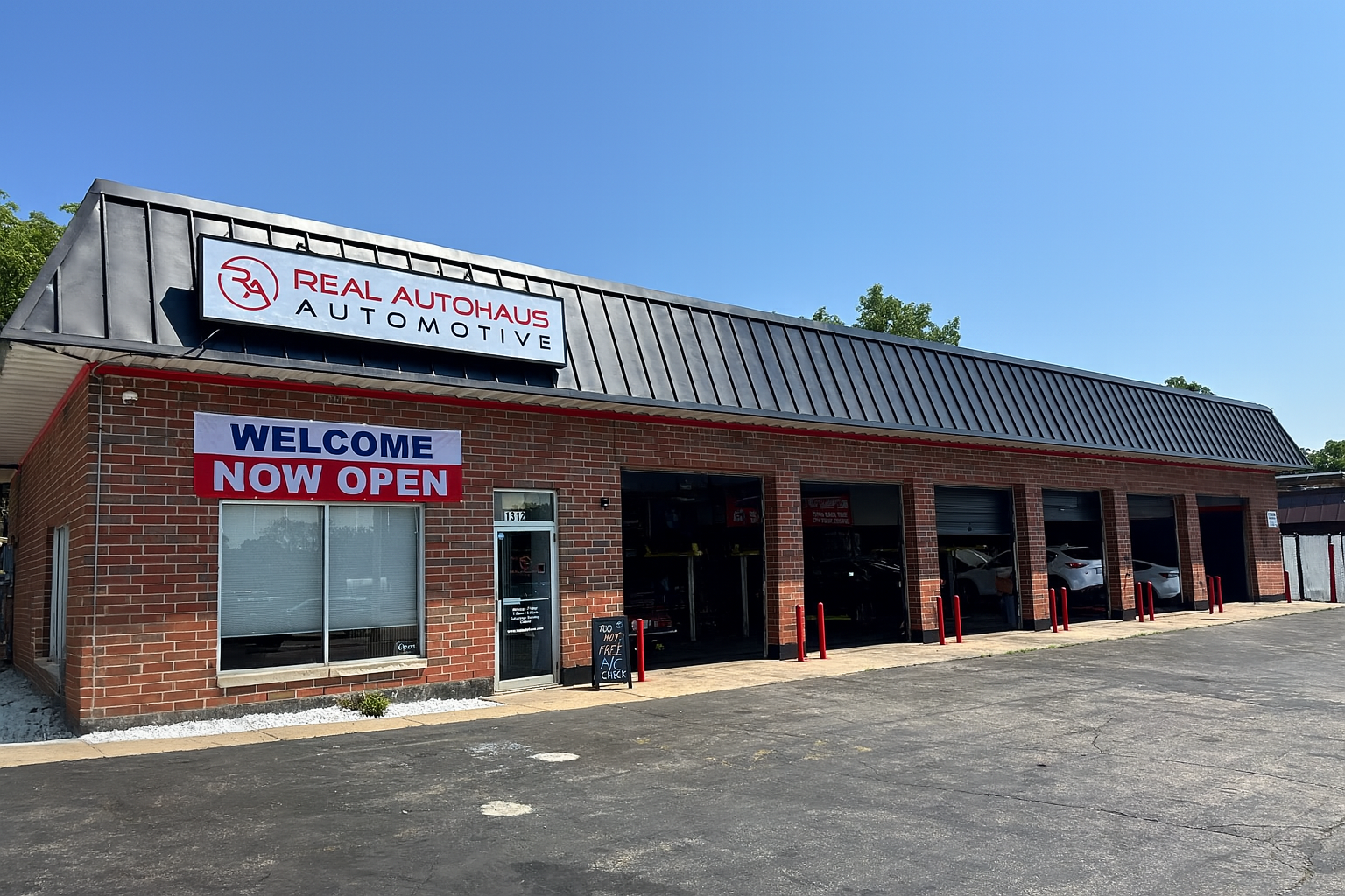 Exterior Of Real Autohaus Automotive Building With Open Bays | Real Autohaus Automotive